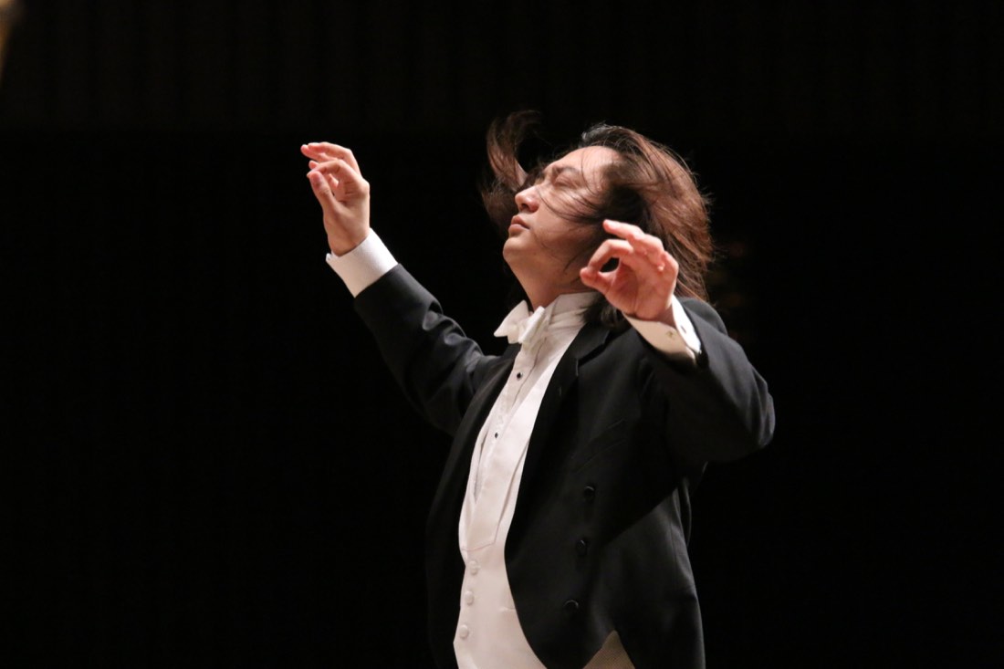 Shizuo Z Kuwahara conducting with both hands raised