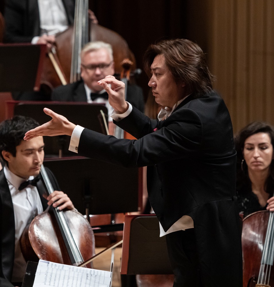 Shizuo Z Kuwahara conducting with orchestral musicians